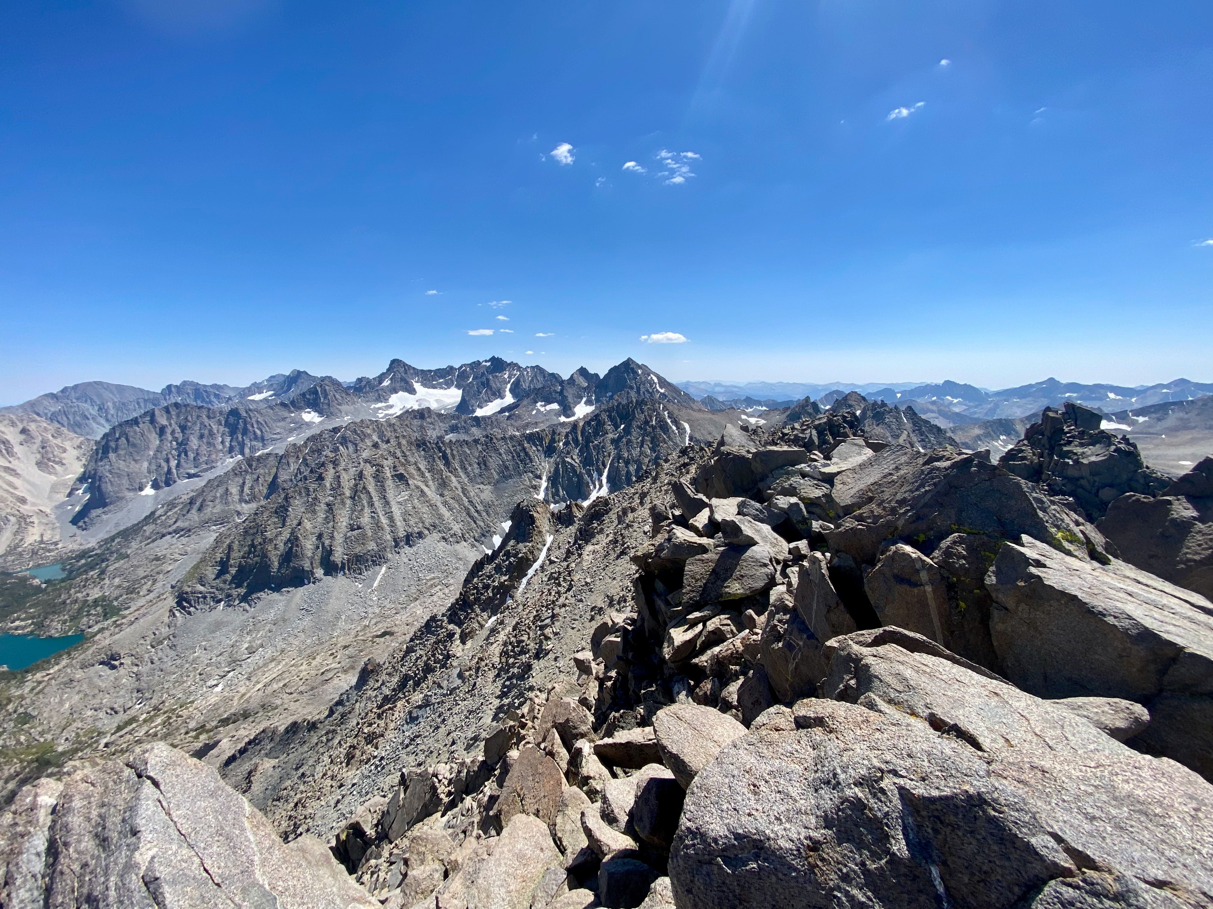Rugged peaks, bright sun, alpine talus at summit