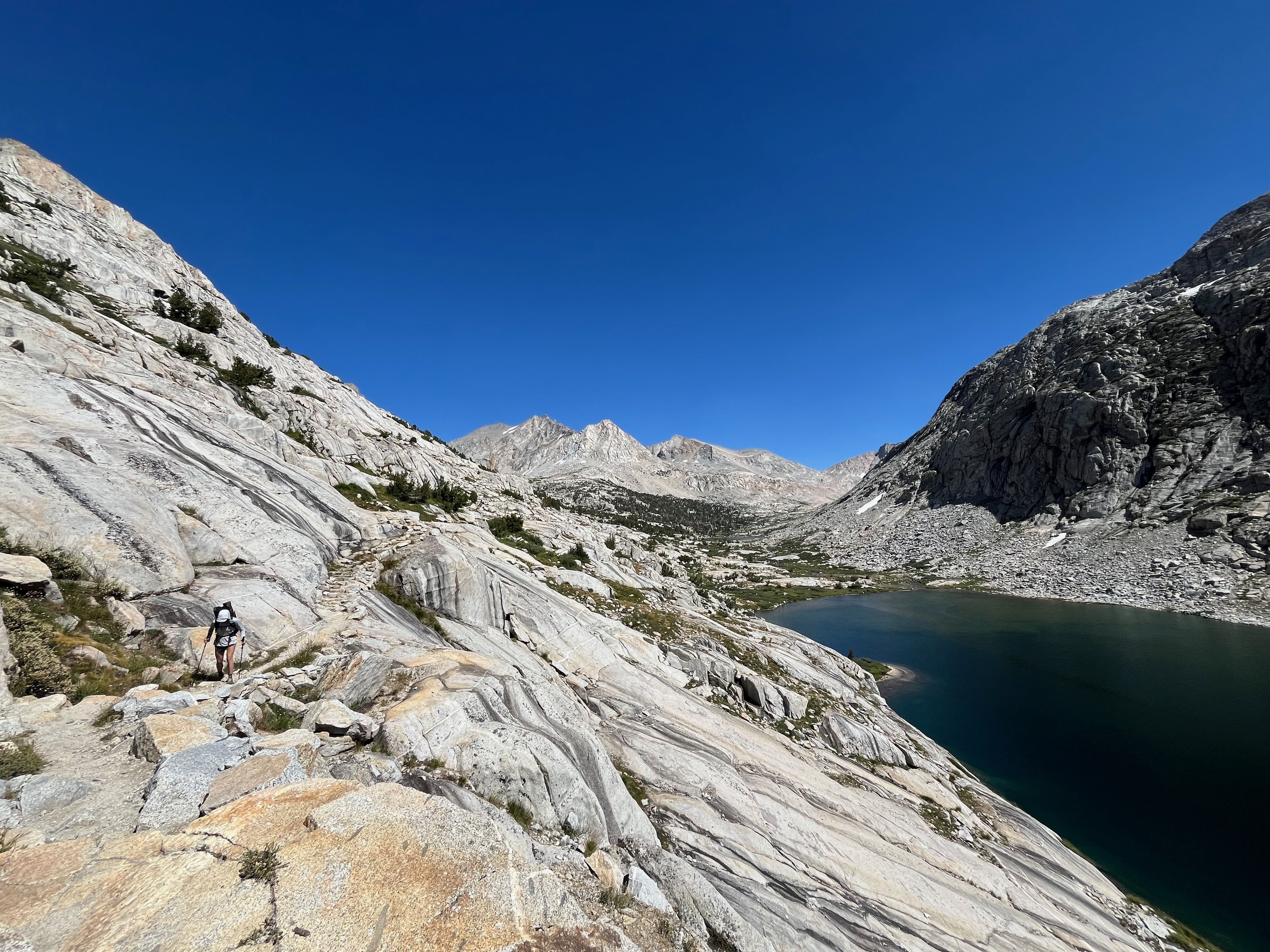 Palisade lake with backpacker on trail