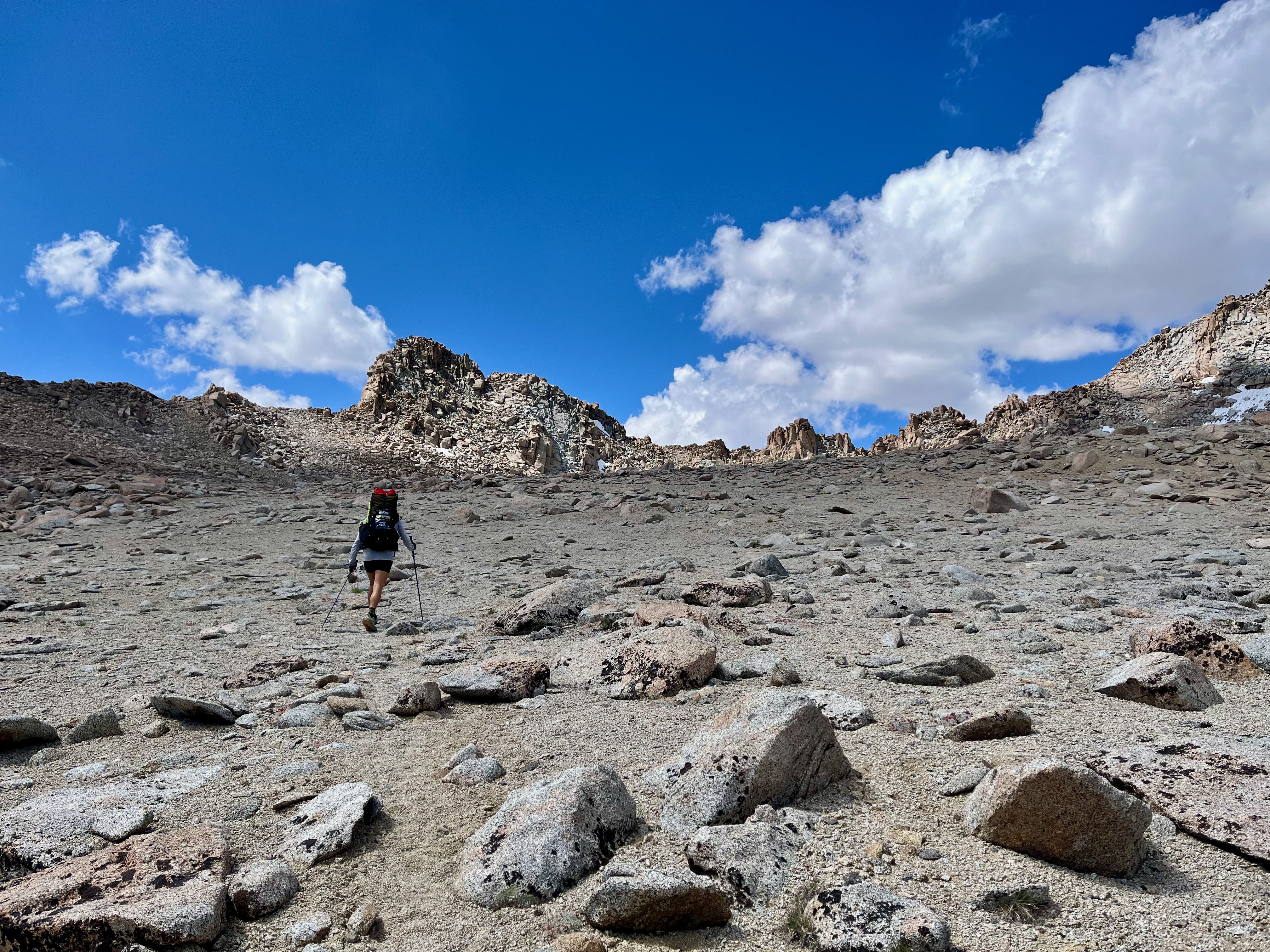 Hiker ascending Lamarck Col with big backpack