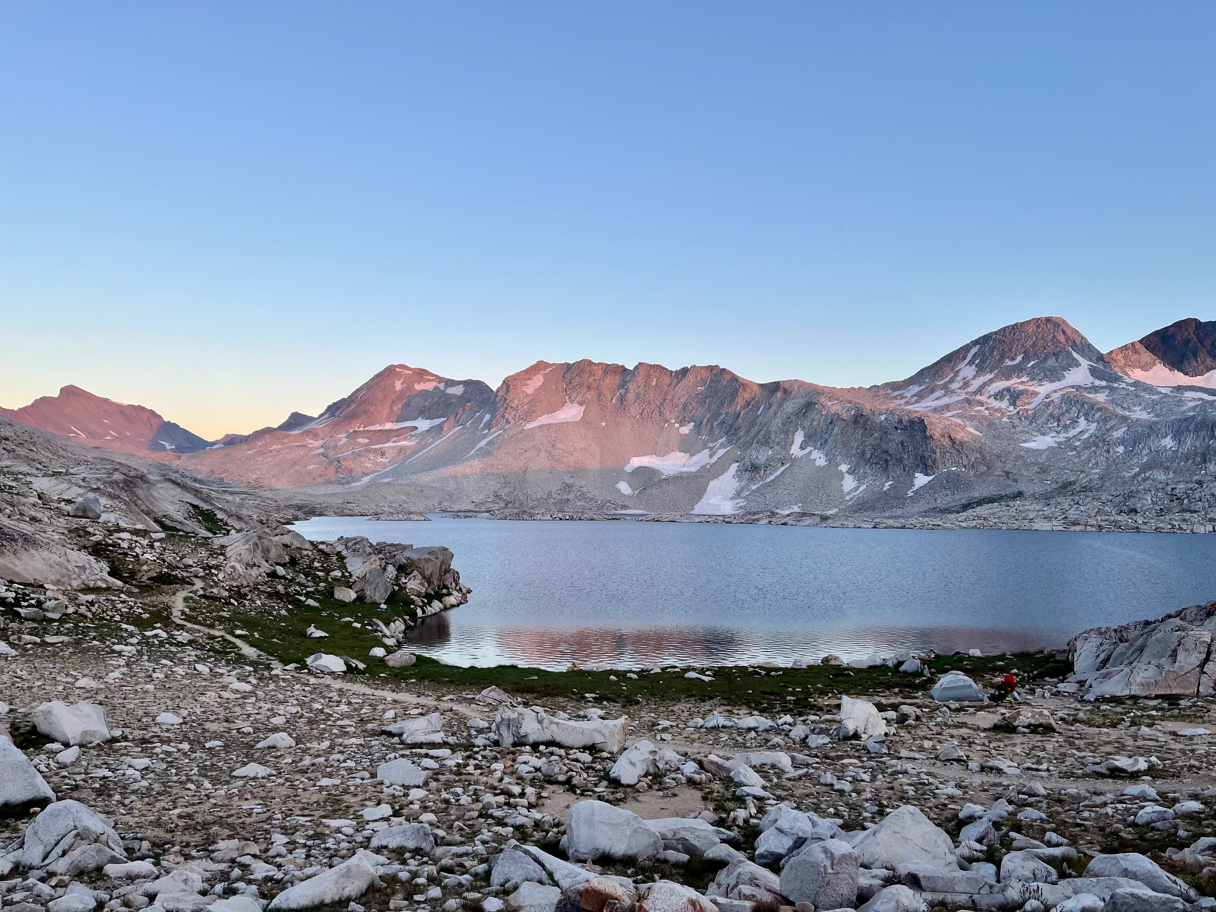 Evolution basin in the high sierra at dawn, pink sunrise on wanda lake with mountains