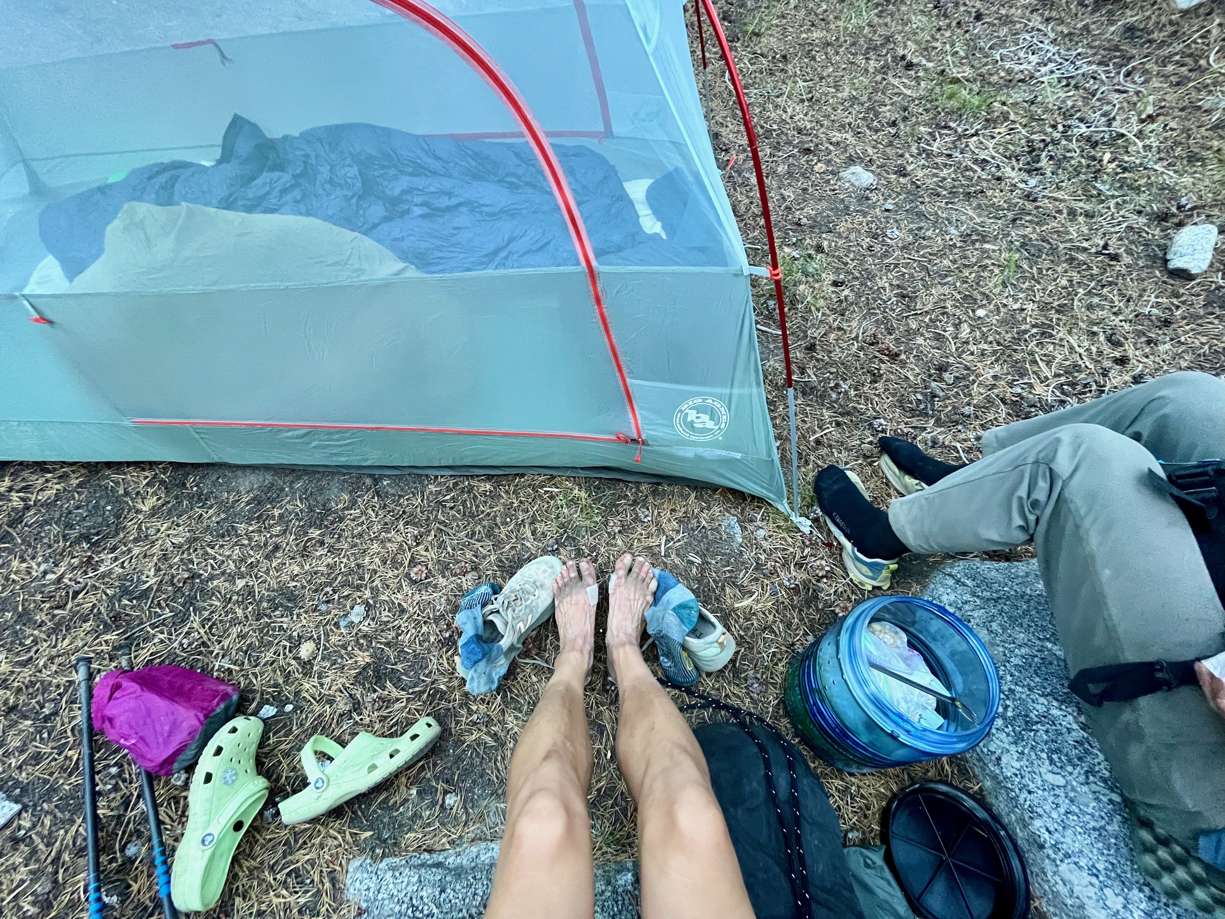 Dirty hiker feet next to tent