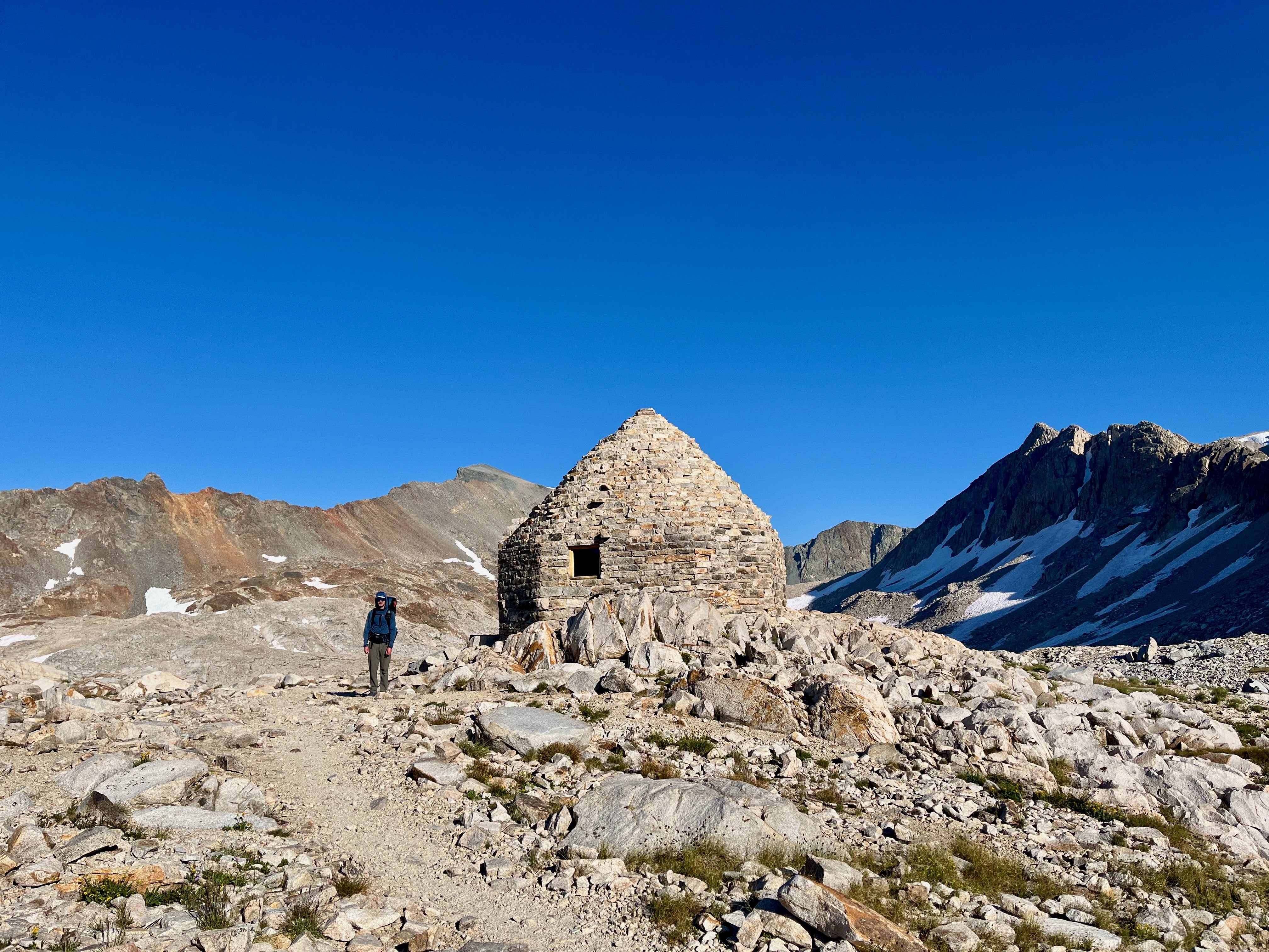 Hiker standing next to John muir hut